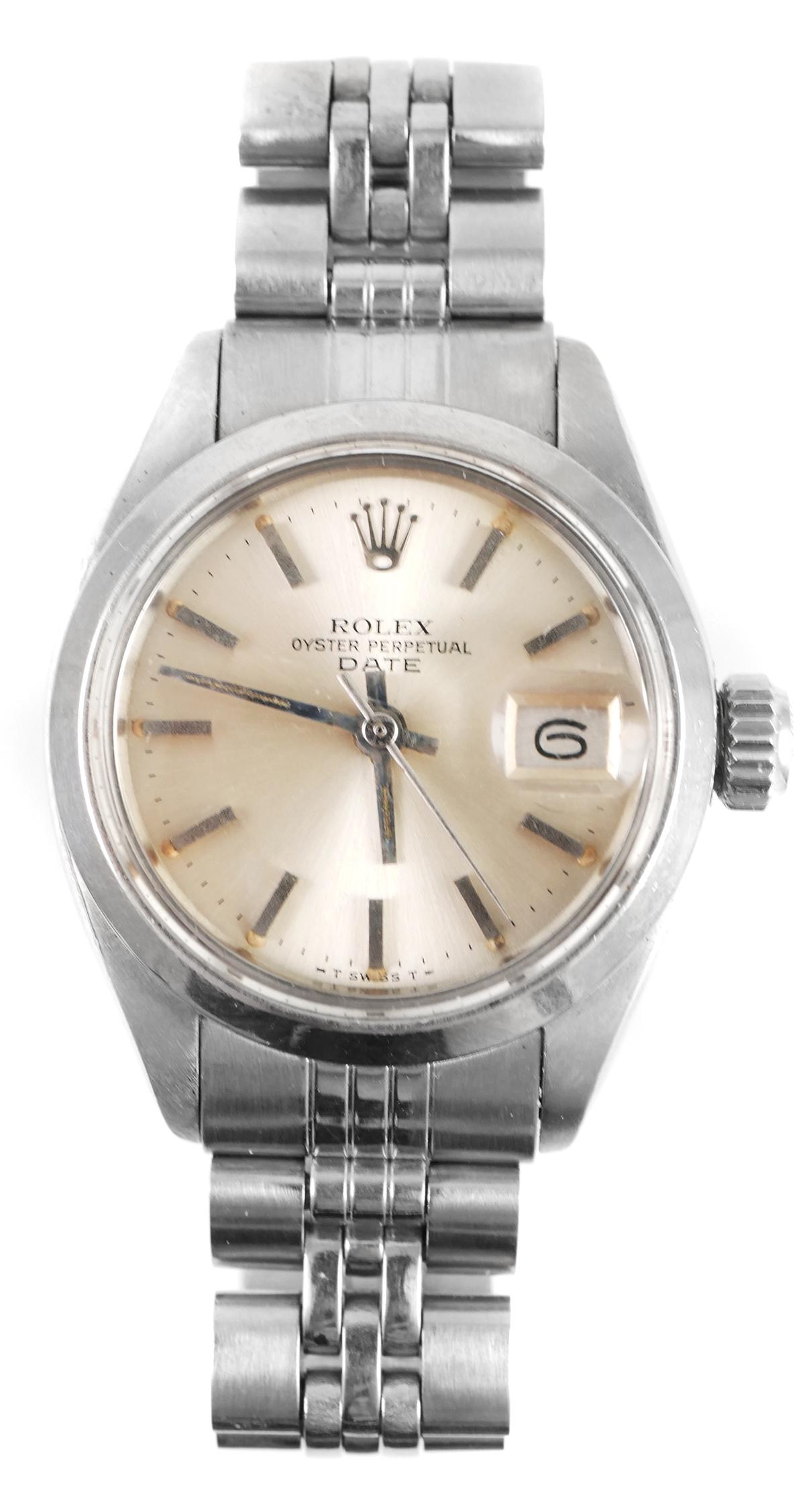 ROLEX Stainless Oyster DATE Ladies Watch: Circa 1980 Rolex ladies stainless steel Oyster Perpetual Date wristwatch. Automatic, runs. Very fine condition. About 1" wide at widest point, not including crown. Comes with old, torn warranty dated