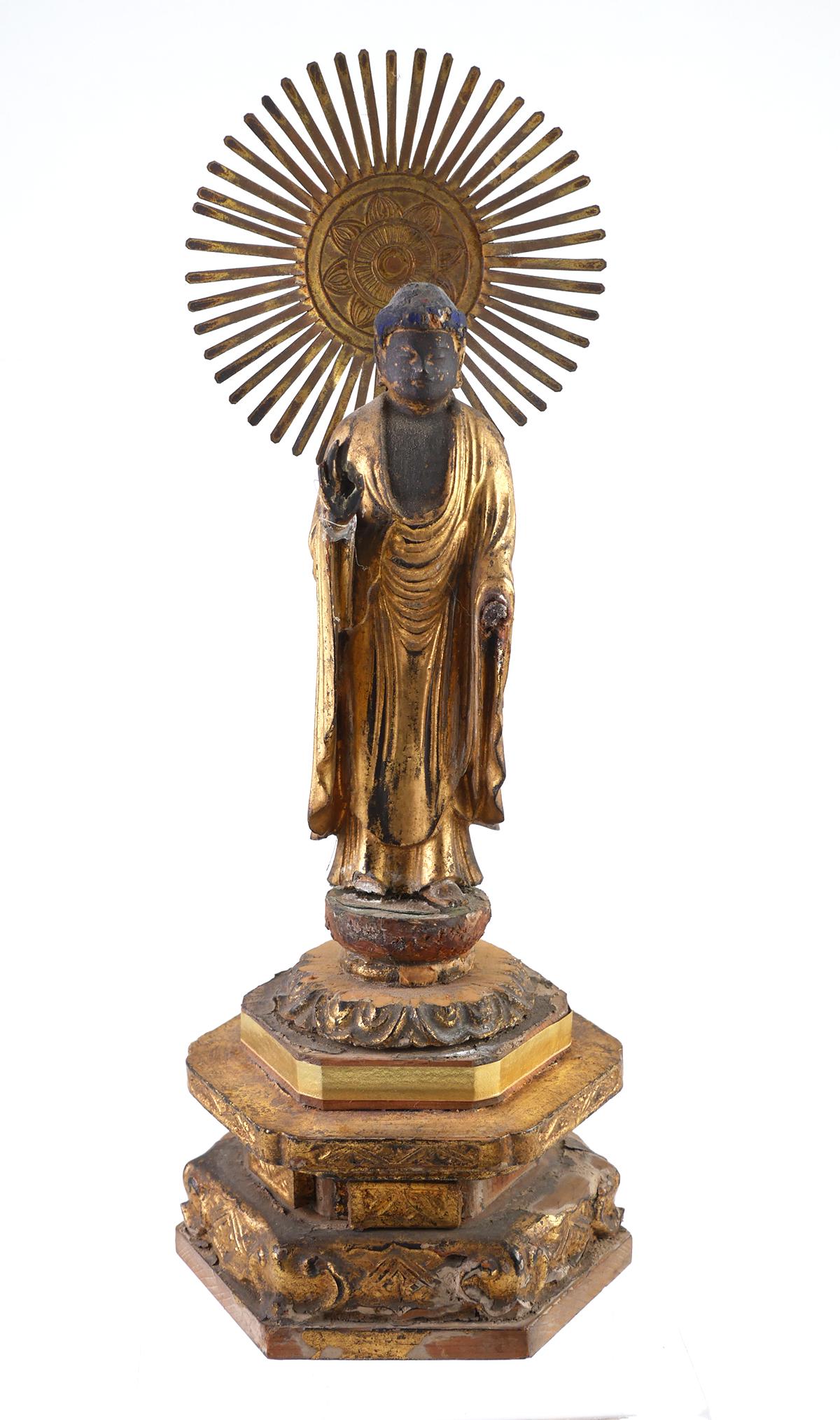 Carved Wood & Gilt Buddha Statue: Antique carved wooden statue of Buddha decorated in gilt and colors. Metal sunburst. Very good condition with some loss to surface decoration, including attached elements and minor chipping. Measures 