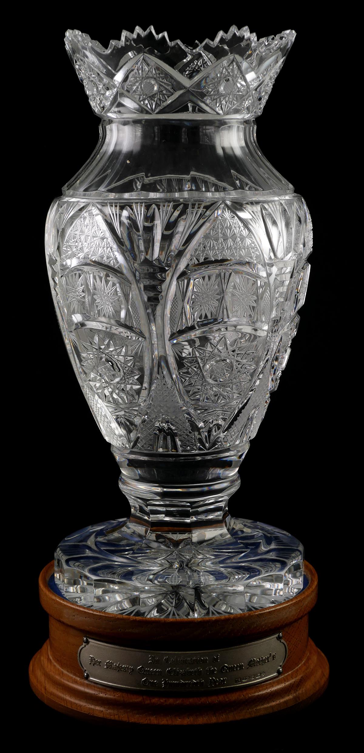 Bohemian Czech Queen Elizabeth Crystal Vase: Bohemian Czech Republic hand cut lead crystal numbered limited edition celebration of Queen Elizabeth vase. Royal coat of arms of the United Kingdom is etched on side of vase. Base has hallmarked ster