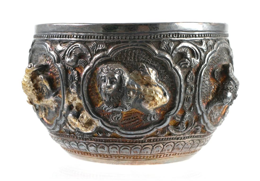 Burmese Silver Repousse Bowl: Highly detailed and hand-chased antique silver repousse Burmese bowl, measuring a little over 3" diameter. Each of the six panels depicts a different animal in high relief.
