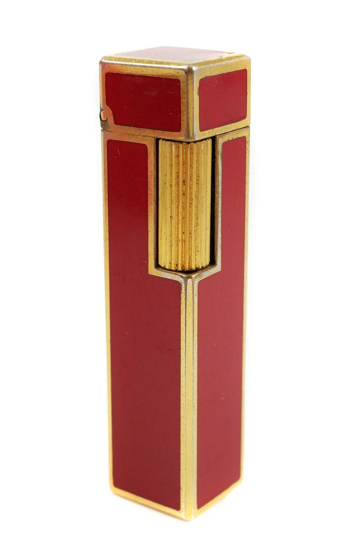 Vintage CARTIER Red Lacquer Lighter: Needs fluid. Sparks when striker is flicked. Measures about 2-3/8" long. Comes with original Cartier case.