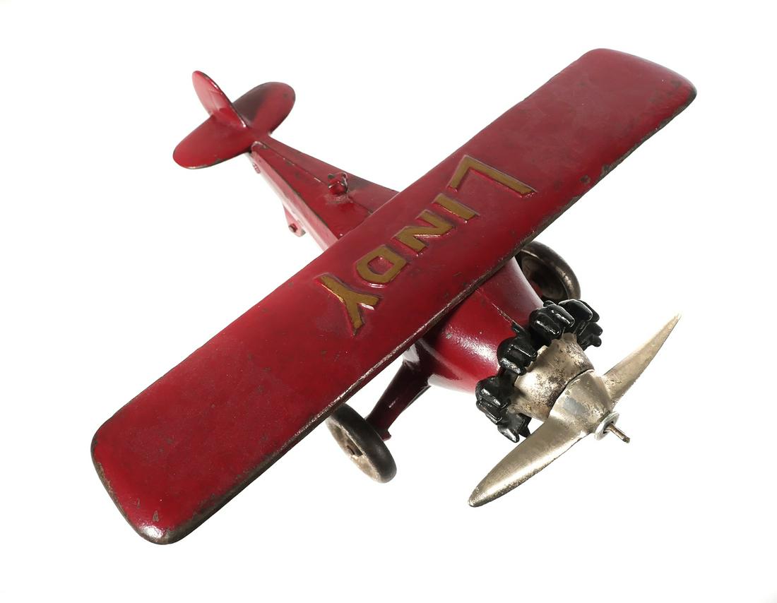 HUBLEY Cast Iron Red LINDY Toy Airplane: Hubley cast iron red "LINDY" Spirit of St. Louis monoplane. 10" wingspan x 9 1/2" long. Plane has wear & paint loss. Propeller drive shaft & gears are missing. One cylinder on radial engine is missing