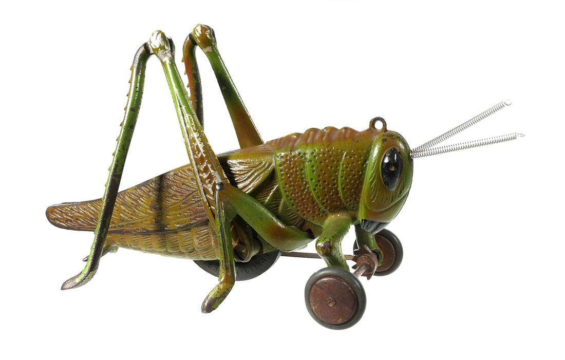 HUBLEY Cast Iron Daddy Long Legs Grasshopper: Hubley "Daddy Long Legs" grasshopper pull toy. Animated legs, cast iron body w/large black eyes & spring antennas. Rear legs move separately & gear on axle makes a "clicking" noise as it walks. Toy is