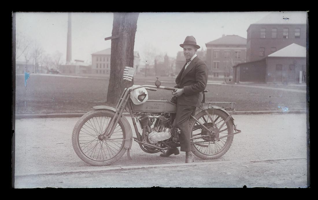 Antique Glass Negative, 1915 Harley Davidson: Antique glass photographic negative of a man sitting on a motorcycle, which appears to be a 1915 Harley Davidson. Excellent negative in excellent condition. Measures 5 1/2" wide x 3 3/8" high.