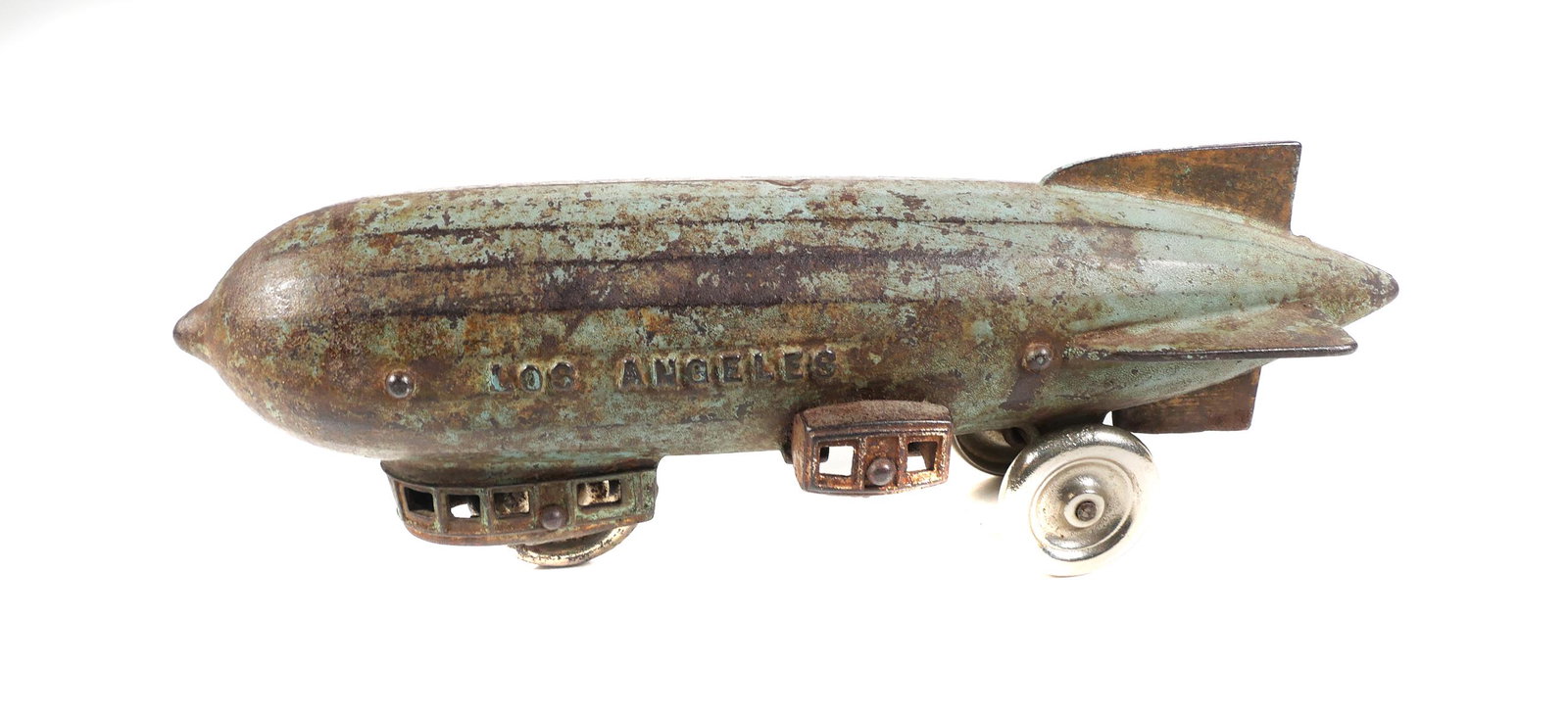 Cast Iron Los Angeles Zeppelin Dirigible Blimp Toy: Cast iron "Los Angeles" zeppelin toy. Possibly Dent or Kenton airship measures 11" in length. Toy has wear & paint loss. Blackwell Auctions guarantees the authenticity of this item. PLEASE call or ema
