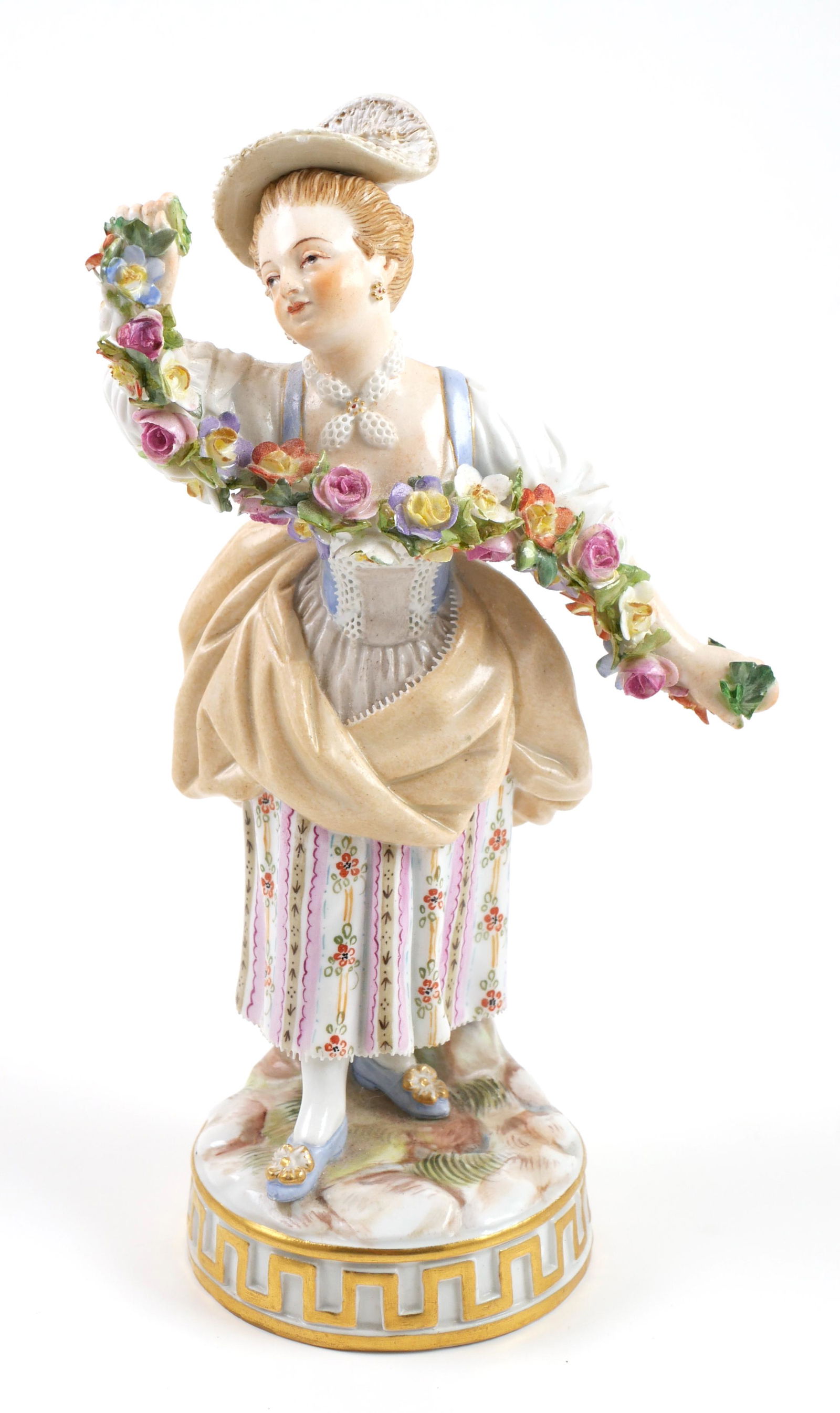 MEISSEN Figurine Girl w Garland: First-quality crossed swords mark Meissen figure of a woman holding a garland of flowers. Measures about 6-1/2" high. Fine condition, with no damage.