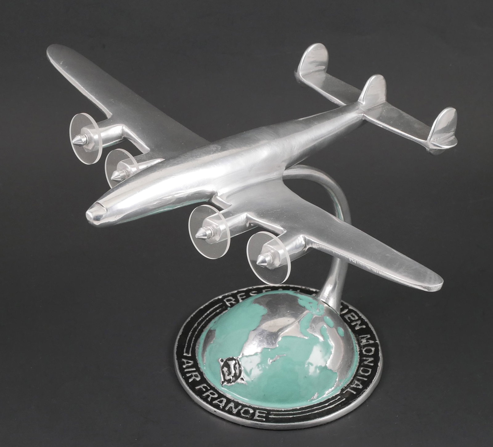 AIR FRANCE Desk Model Plane Starliner: Desktop aluminum model of the Lockheed L1649 Starliner, first flown by Air France in 1958. Model wingspan of 10-1/2" and the nose stands 6" above your desk and features unique clear plastic propeller 