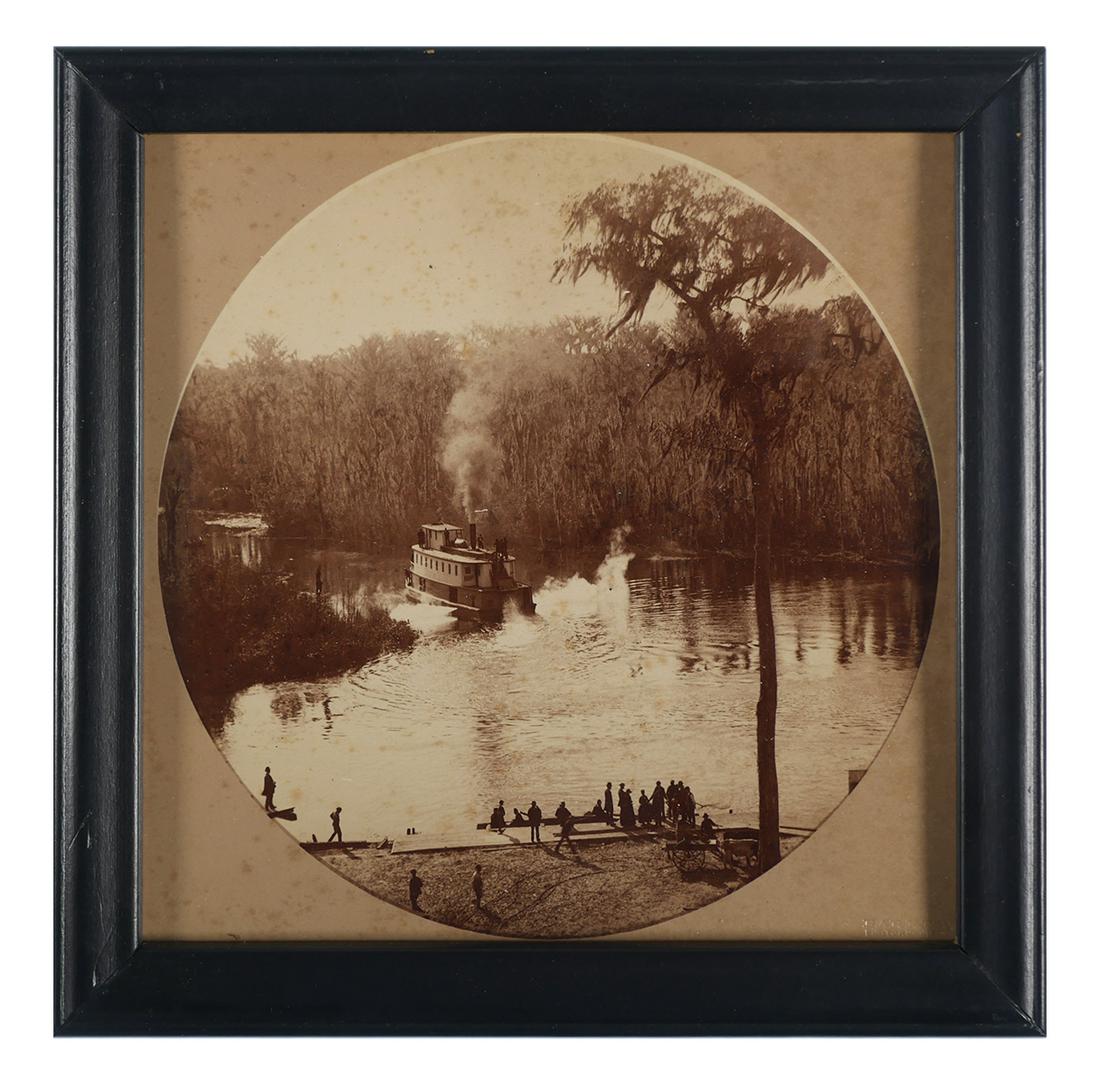 GEORGE BARKER, Florida Riverboat Photograph: 1886 photograph of a steamboat on a Florida river. Attribution for George Barker, Niagara Falls, New York at lower right and verso. Image measures approximately 6" diameter, framed to 8" x 8". Excelle