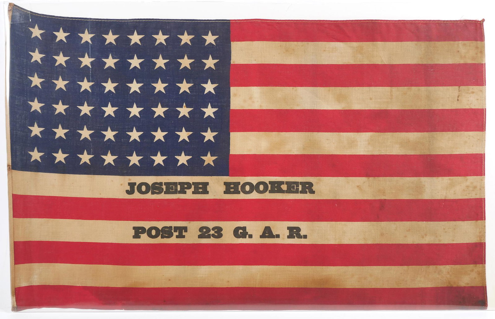 1920s 48-Star Joseph Hooker US Flag, GAR: Antique US flag with "Joseph Hooker, Post 23 GAR" printed on it. Post 23 was located in East Boston. Flag has some toning and spots, as shown. Measures about 14" x 23".