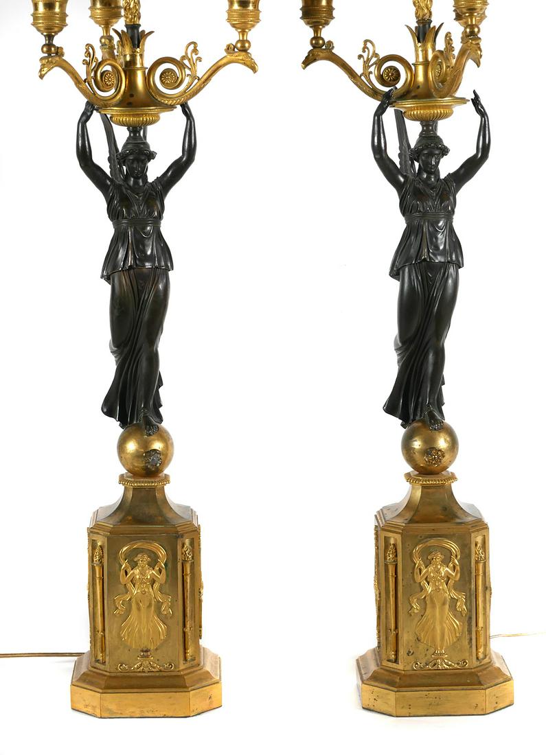 French Empire Candelabra, Bronze, Victory-Form: French antique candelabra pair, Empire or Restoration Period, early 19th century, in patinated and gilt ormolu bronze; each with five lights, the central atop a flame support and the surrounding four