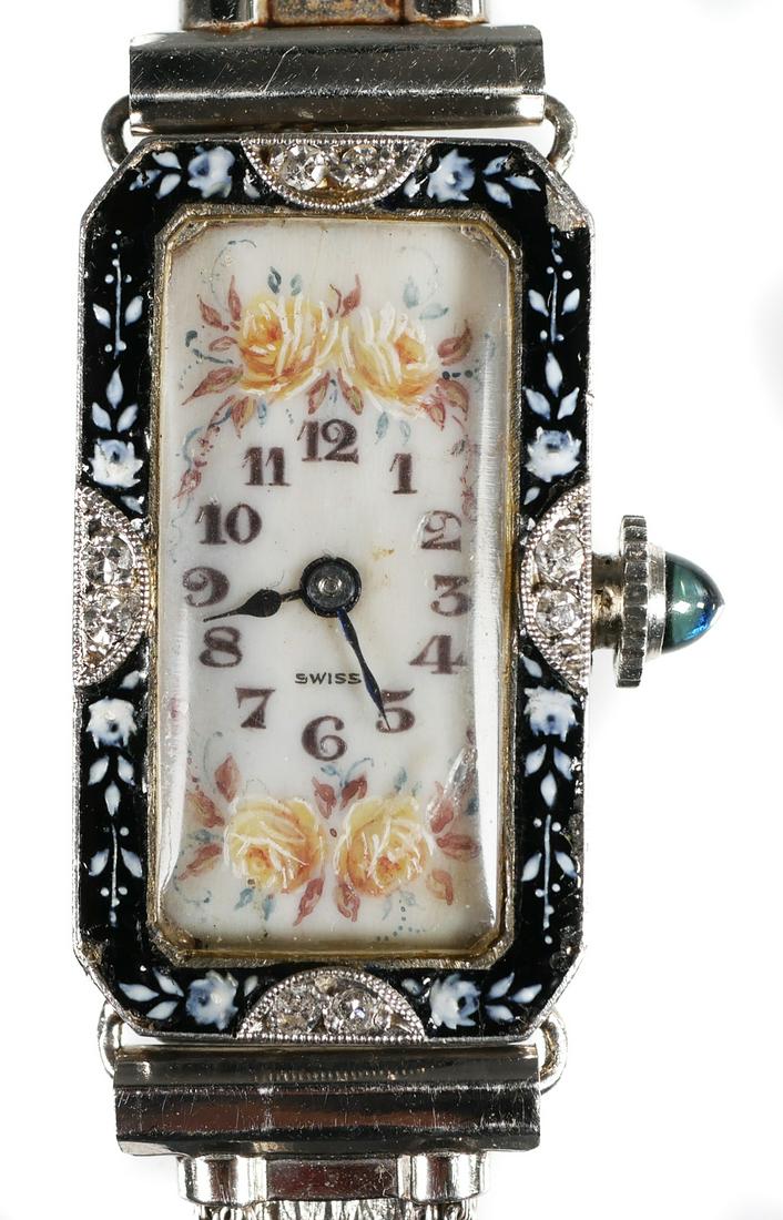 PATEK PHILIPPE Art Deco Platinum Watch: Ladies' Patek Philippe wristwatch with platinum case. Handpainted dial surrounded by painted enamel frame, accented with four diamonds. Minute flake in upper right corner of enameling. Movement marked