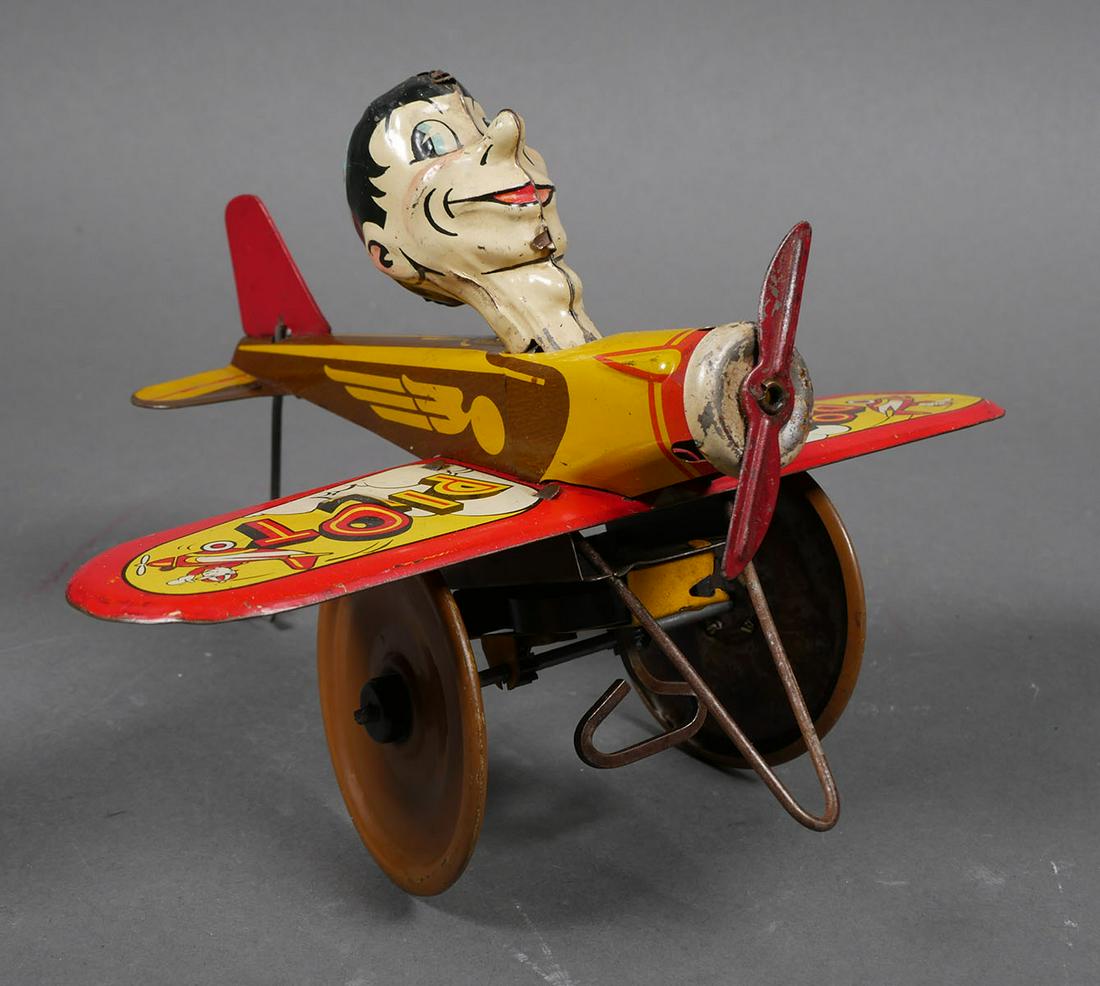 MARX Tin Windup ROOKIE PILOT: Louis Marx "Rookie Pilot" tin lithograph key wind up mechanism toy airplane & pilot. Wingspan is 8", overall length is 7". In working condition. Normal wear & paint loss/scratches - see photos.