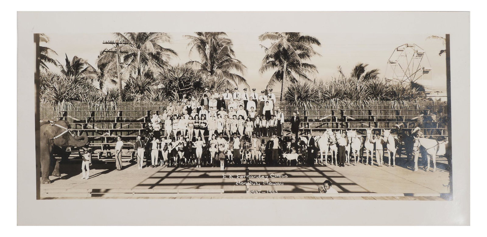 Fernandez Hawaii CIRCUS Photograph, 1940s: Mounted gelatin silver print photograph of a circus in Honolulu Hawaii, identified in the negative as the "E.K. Fernandez Circus." Dated 1947-1948. Excellent condition. Overall size is 17" x 8".