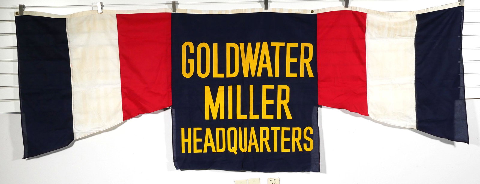 BARRY GOLDWATER Campaign Headquarters Banner: 1964 US Presidential campaign banner for Goldwater/Miller. Grommets along top edge. Banner measures 38" x 104". Some wear, as shown in images. Good condition overall.