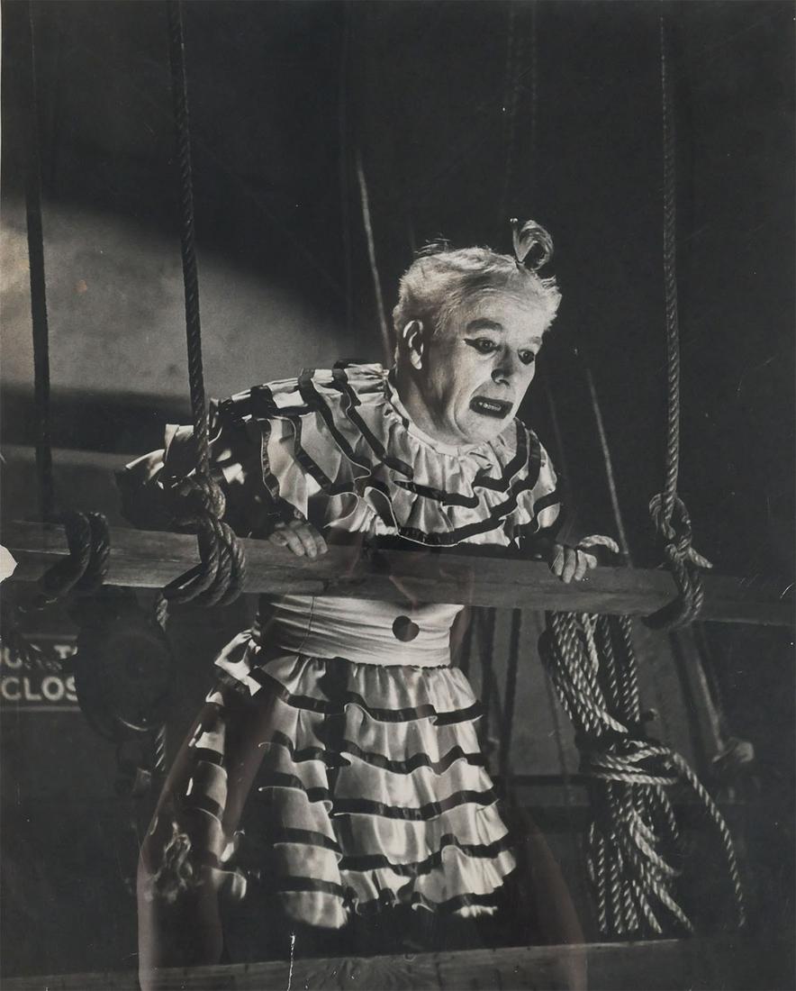 W. Eugene Smith, CHARLIE CHAPLIN Set Photo: Large silver gelatin photograph print of Charlie Chaplin in clown makeup on the set of Limelight (1952). Likely by set photographer W. Eugene Smith (American, 1918-1978). Measures 16" x 20". Photo has