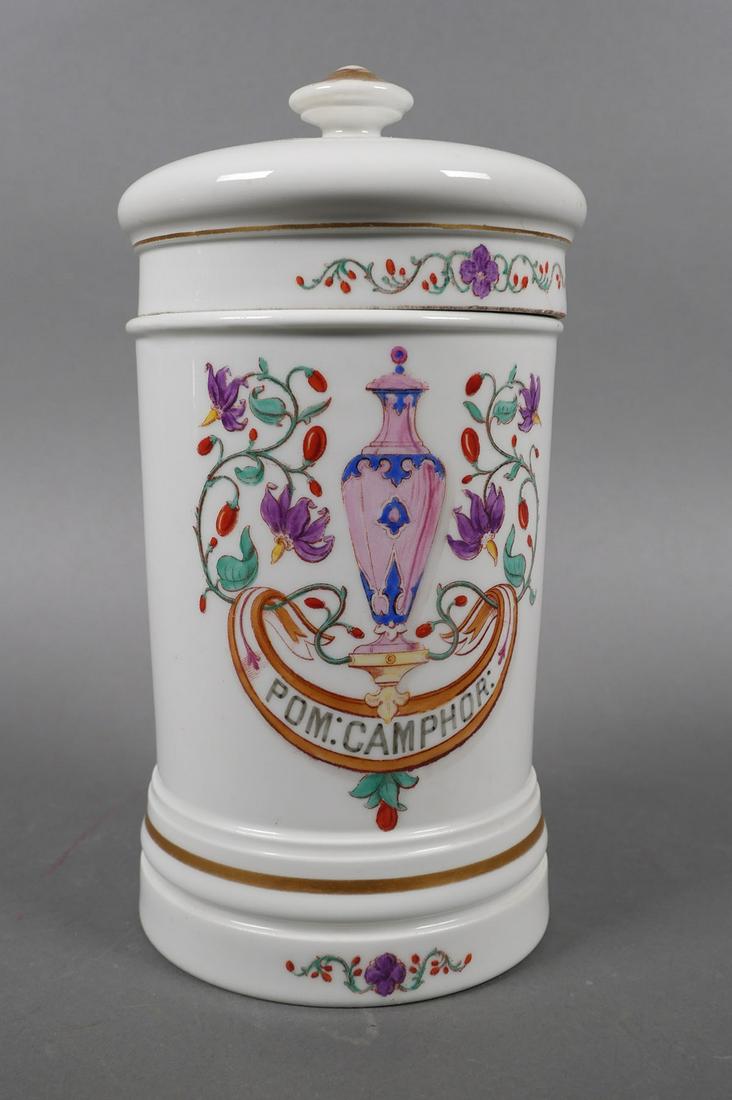 Antique French Porcelain Apothecary Lidded Jar: Antique hand painted French apothecary, medicine or drugstore lidded jar, decorated with floral cartouche reading, "Pom: Camphor:", gilt accents and finial. Marked on underside, Verreries P. Lefebure 