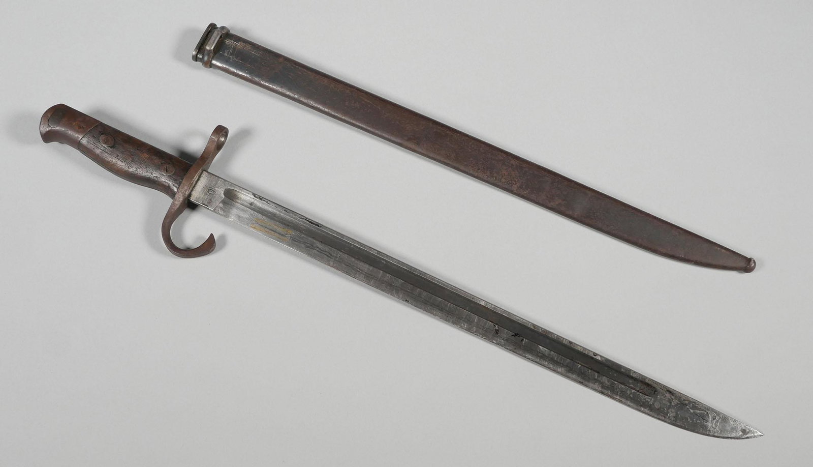 WWII Japanese Type 30 Bayonet Tokyo Arsenal: Japanese Arisaka bayonet serial #3074447. 15 5/8" blade, 20" overall. Bayonet & scabbard have age appropriate wear & oxidation. Scabbard has some dents. See photos for more details on condition.