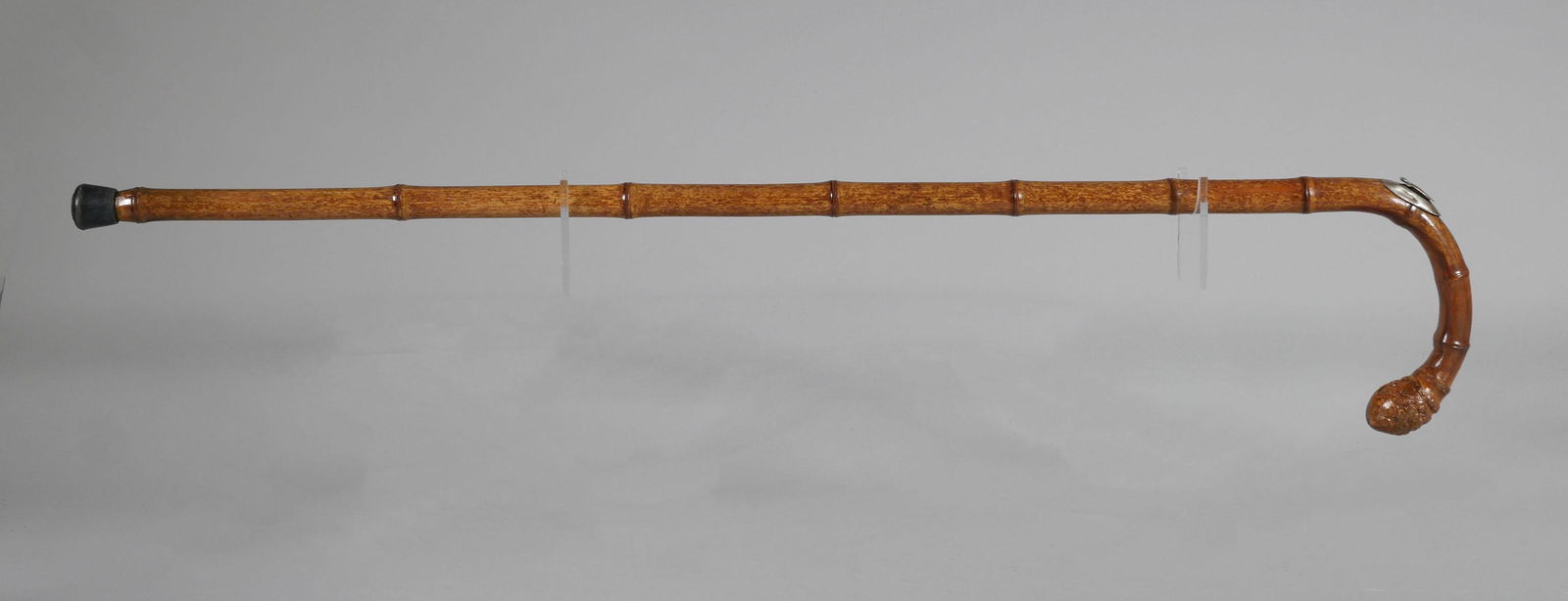Antique Horse Measuring Walking Stick: English antique bamboo walking stick with sterling silver capped measuring stick (signed Geo Parker & Sons, London) for measuring horses (up to 17 hands). Stick measures 37-1/2" long.