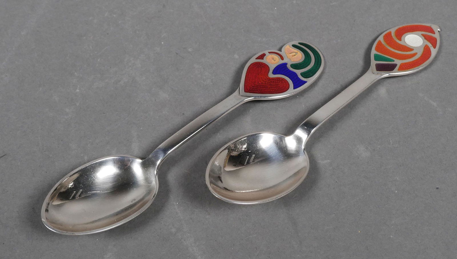 (2) Michelsen Denmark Sterling Enamel Spoons: Two sterling silver Christmas spoons, 1968 and 1971, by Danish silversmith A. Michelsen. Each measures about 6-1/4" long.
