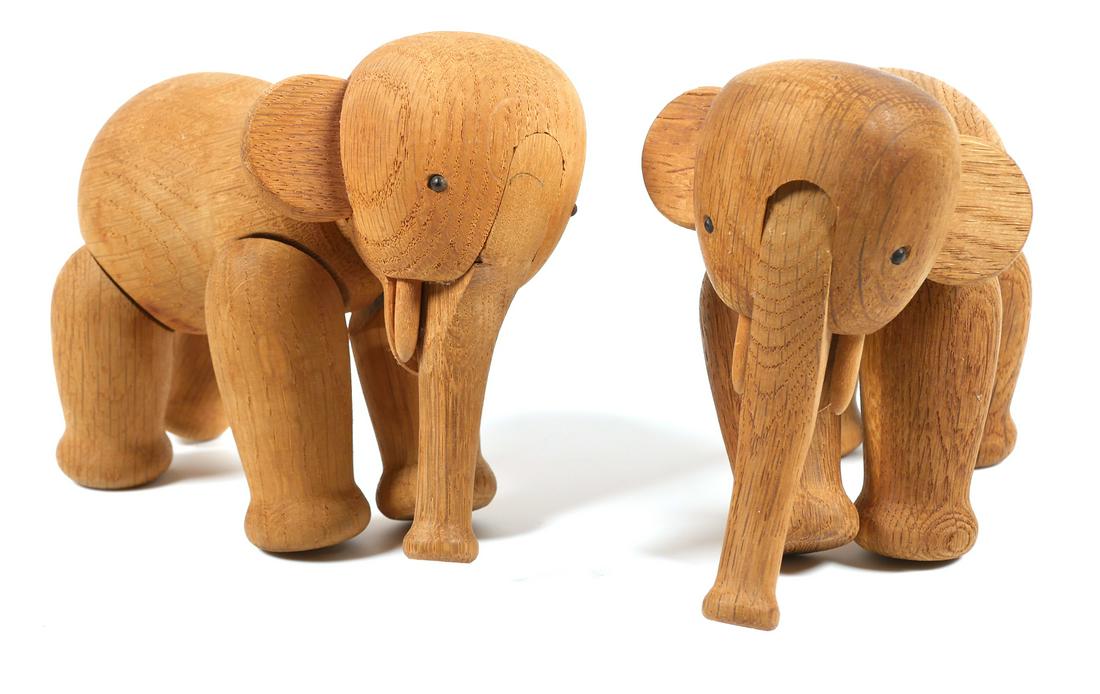 (2) Vintage KAY BOJESEN Toy Wood Elephant: Two Mid Century Modern carved wood toy elephants, with articulated trunk and legs. Both toy models are marked on bottom of foot, Kay Bojesen, Denmark, copyright. Elephants measure approx. 6" x 5" x 4"
