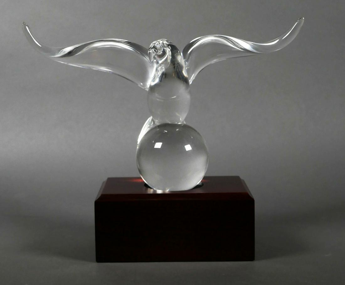Steuben Glass Eagle with Stand: Signed Steuben blown glass eagle with wooden stand. Measures 9 3/4" tall including stand. Excellent condition with no chips, cracks or damage.