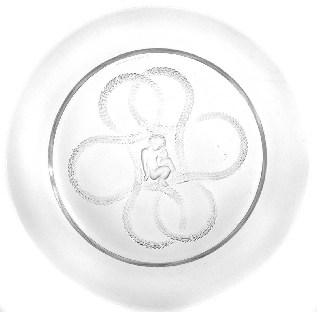 Lalique France Olympe Intaglio Cherub Glass Plates: Set of 6 glass French Lalique plates with a cherub or young child sitting in the center of a long garland of leaves intertwined in an eternity love knot. Plates measure 8 3/8" in diameter making them 