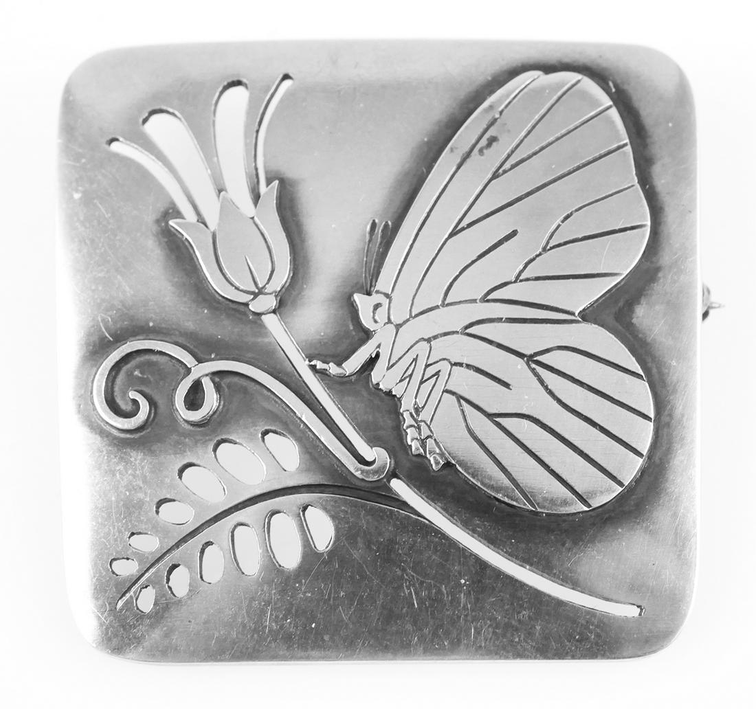 GEORG JENSEN Sterling Butterfly Brooch 294: Signed Georg Jensen 925 sterling modernist butterfly and tulip brooch #294. Designed by Arno Malinowski, a butterfly perches on the stem of a flower. The butterfly and flower are raised above the surf