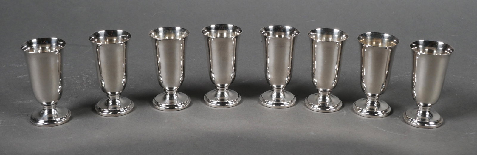 (8) STERLING Silver Footed Cordial Liqueur Cups: Eight footed sterling silver cordial or shot cups. All are marked STERLING 950, no makers mark. Cups measure 2 3/16" tall x 1 3/16" diameter. Total weight is 130.3 grams. Cups have normal wear with li