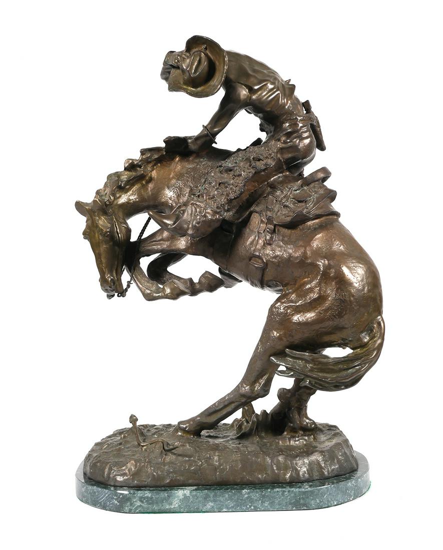 FREDERIC REMINGTON Bronze Sculpture: "The Rattlesnake" bronze sculpture, after Frederic Remington. Bronze is signed Frederic Remington. The sculpture depicts a cowboy riding a horse that is rearing up in fright, twisting away from a ratt