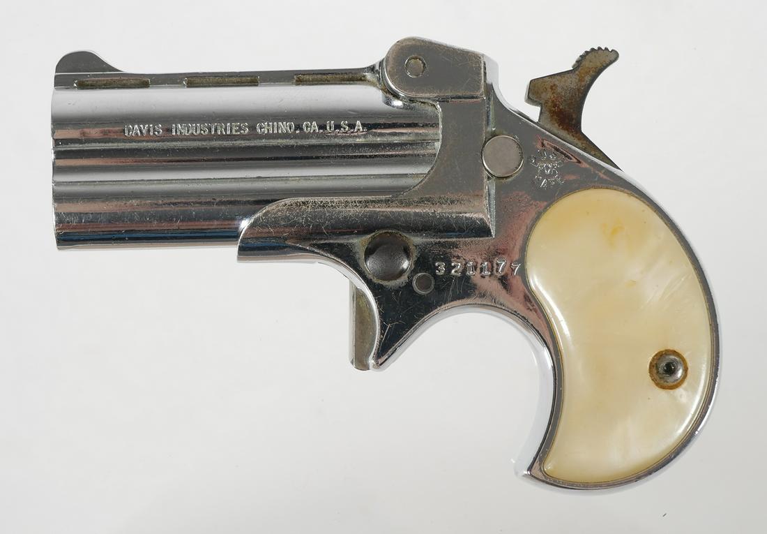 Davis Industries DM-22 Derringer Pocket Pistol: Davis Industries Model DM-22 over/under derringer in .22 Magnum. Serial #321177. Barrel measures 2 3/8". Normal wear to chrome finish. Grips have normal wear commensurate with age, no chips or cracks.