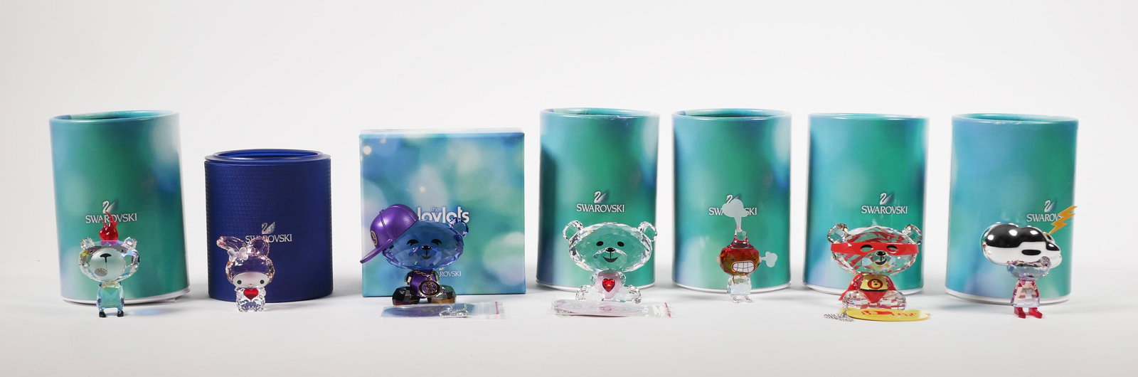 (7) Swarovski Crystal Figurines Lovlots: Group of 8 Swarovski crystal figurines, set includes: Hello Kitty Sanrio My Melody Red Heart, Emoti Burning Desire, Bo Bear Hip Hop Bo, Bo Bear So Sweet, Super Bo, Emoti Energy, Emoti Anger. Each is M
