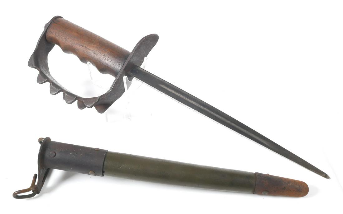 WWI US Model 1917 Trench Knife: American Cutlery Company World War I M1917 trench knife and scabbard. Known as a “Knuckle Duster”, the knife has a D-shaped hand guard with triangle shaped “Knuckles”. Marked inside the guard,