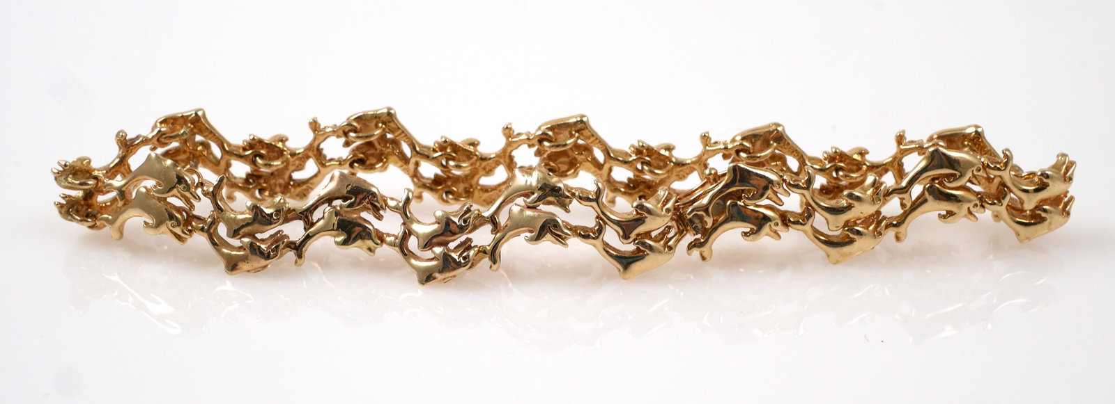 14K Yellow Gold Double Dolphin Bracelet: Brilliant 14K yellow gold double dolphin bracelet. Everlasting design. Bracelet measures 7 1/2" long and is secured by a box clasp with safety. Total weight is 22.2 grams. Very good condition with lig