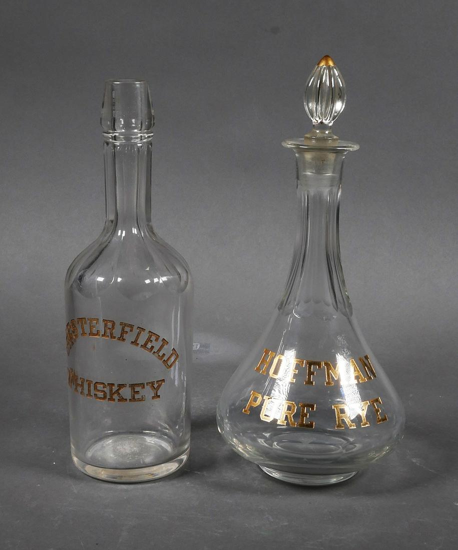 (2) Bottles Hoffman Pure Rye Chesterfield Whiskey: (2) antique whiskey bottles. 1) Decanter with stopper marked with etched gold lettering "Hoffman Pure Rye", approx. 11 1/2" tall x 5". 2) Bottle with etched gold lettering "Chesterfield Whiskey", appr