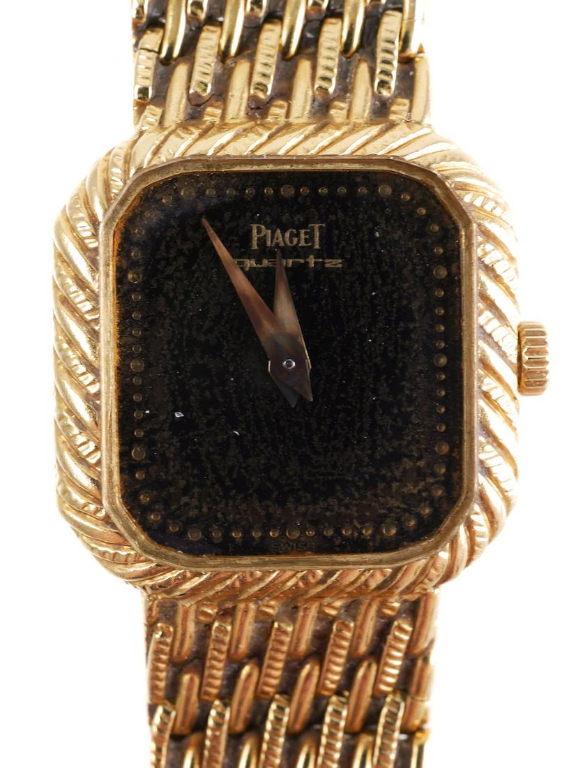 Vintage Piaget 18K & Onyx Ladies Watch: Women's Piaget Swiss watch set in 18K yellow gold. Watch features a square onyx dial with gold fleck and 18K mesh band 6" in length. 20mm case is hallmarked 750. Total weight 38.6 grams. Pre-owned wit