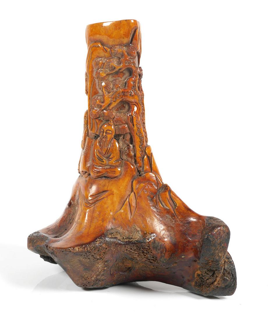 Chinese Carved Bone Sculpture: Carved bone section depicting a landscape scene with two wise men or scholars playing a game under trees with a Chinese temple on hilltop. Carving sculpture measures 6 1/2" tall x 5 1/2" across.