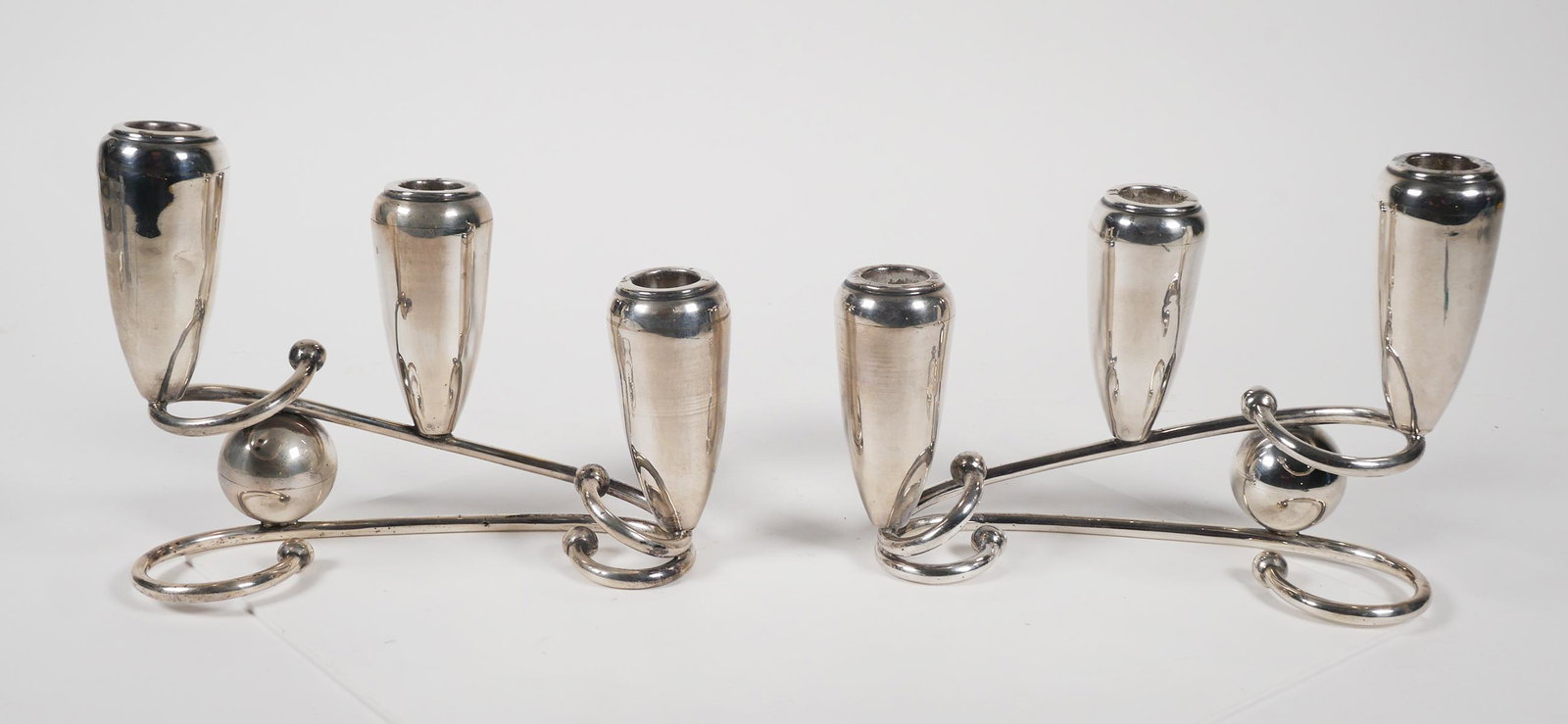 Pair ZURITA Mexican Sterling Silver Candelabra: Pair of Mexican three light sterling silver modernist candelabras. A graduated trio of holders with counter balanced design using a silver ball or sphere to support each end. Hallmark stamped "C. Zuri