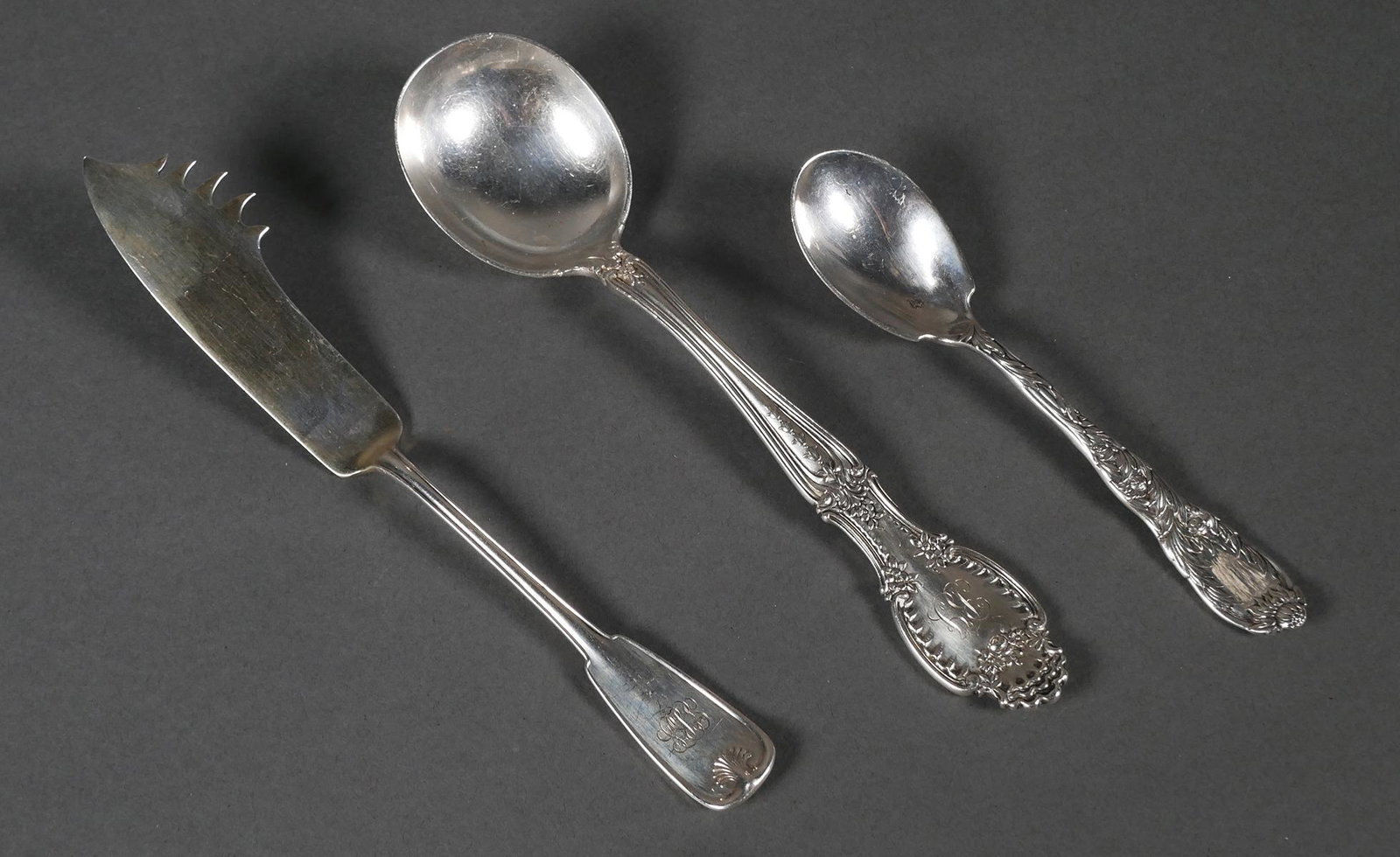 (3) Tiffany & Co. Sterling Cheese Knife Spoons: Three Tiffany and Company sterling silver pieces. Cheese knife with pick in Palm pattern, monogrammed, 8 1/4", 53.2 grams, Chrysanthemum pattern spoon, scratched monogrammed 5 3/4", 49.3 grams, Richel