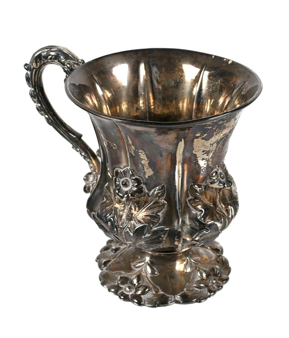 English Sterling Floral Repousse Cup: Antique British cup with sterling and London hallmarks. 3 3/4" tall x 3" rim diameter. Approx. 159.9 grams. Monogrammed.