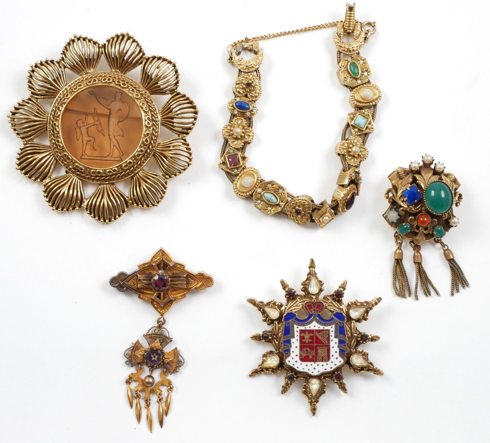 (5) Vintage Costume Jewelry, Brooch Pin Bracelet: Lot of costume jewelry, (4) brooches and (1) Victorian slide charm bracelet. Bracelet is approx. 7" and has some missing stones. Intaglio glass brooch measures 2 3/4" in diameter.