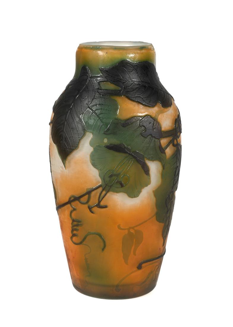 Muller Freres Luneville Cameo Vase: Muller Freres, French art glass cameo vase. Vine and leaf motif in shades of green and dark brown of on orange and white background. Vase measures 6 5/8" tall x 3 1/2" wide. Signed Muller Fres Lunevil