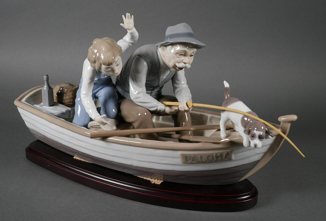 Lladro Fishing with Gramps Figurine 5215: Porcelain glossy figurine of a child with his grandfather in a boat, "Paloma" accompanied by a dog watching the rod with which they are fishing. Sculptor, José Puche. Figurine measures approx. 8 