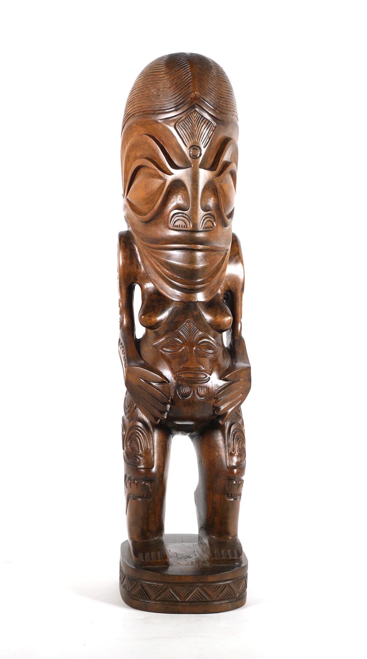 Polynesian Tiki Fertility Statue, 1970s: Large carved wooden Tiki statue from Tahiti, circa 1970s. Finely detailed female with baby showing in statue's belly. Measures 24" tall. Very good condition with three minor wood grain separations.