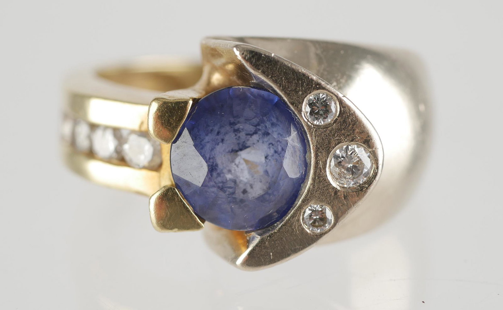 14K Gold Tanzanite and Diamond Ring: 14k two tone gold tanzanite and diamond ring. Approx. 1 ct. tanzanite weight. (8) round brilliant cut diamonds are approx. .25 ct. Size 5, approx. 8.2 grams total weight. GIA appraisal included.