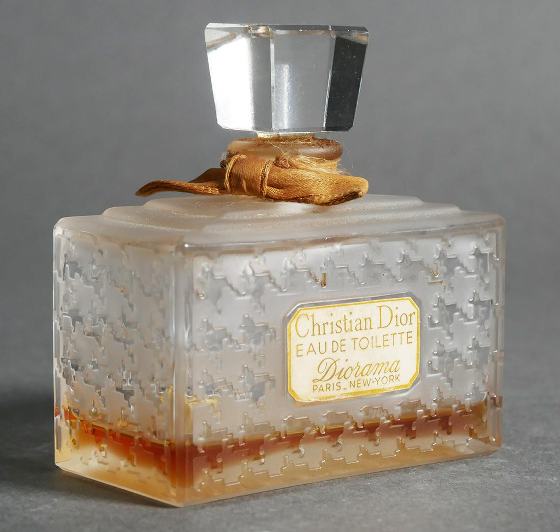 Christian Dior Eau de Toilette Diorama bottle: Christina Dior perfume bottle with a tweed pattern on the flacon, with a square stopper and ribbon tied around the neck, some perfume still in bottle, measures 2 3/4" x 3" x 1 1/2", parfum.