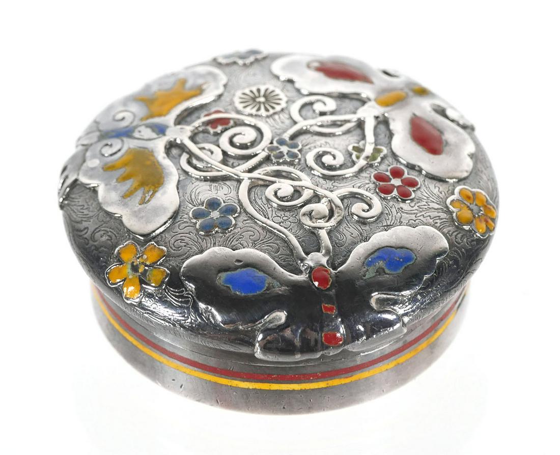 TIFFANY & CO Sterling Pill Box, 1880s: Circa 1880s Tiffany sterling silver screw top pill box with enamel accents (possibly added later). Raised butterfly motif on floral engraved background. Measures 1-5/8" diameter. This item can be ship