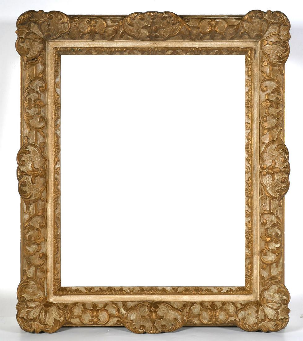 NEWCOMB MACKLIN Style Picture Frame: Empty ornate gilt picture frame with distinctive splines on back corners. Attributed to Newcomb Macklin, but there are no tags or labels to that effect. 26-1/2" x 22-1/2" overall, rabbeted for 20" x 1