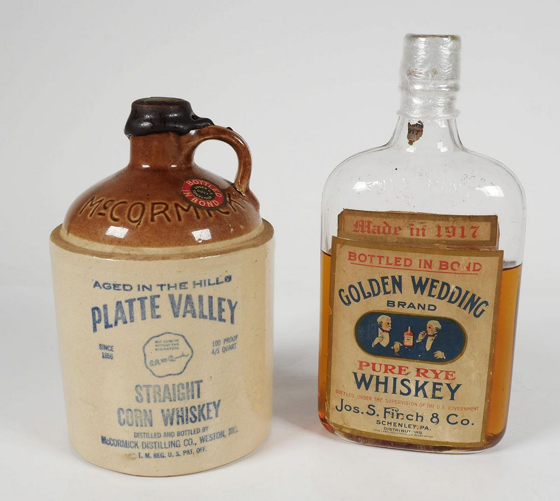 (2) Early 1900s WHISKEY Bottles: Two American whiskey containers from the early 1900s: a Platte Valley Straight Corn Whiskey jug (Missouri) and a Golden Wedding Brand Pure Rye Whiskey pint flask (Pennsylvania). Bottle is dated 1917. 