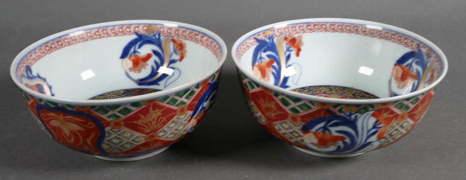 Antique Japanese Imari Porcelain Bowls: Two Imari bowls with floral and geometric motifs, marked with Chenghua mark on bottom, measure 2 1/2 x 5 5/8 inches. This item can be shipped in-house.