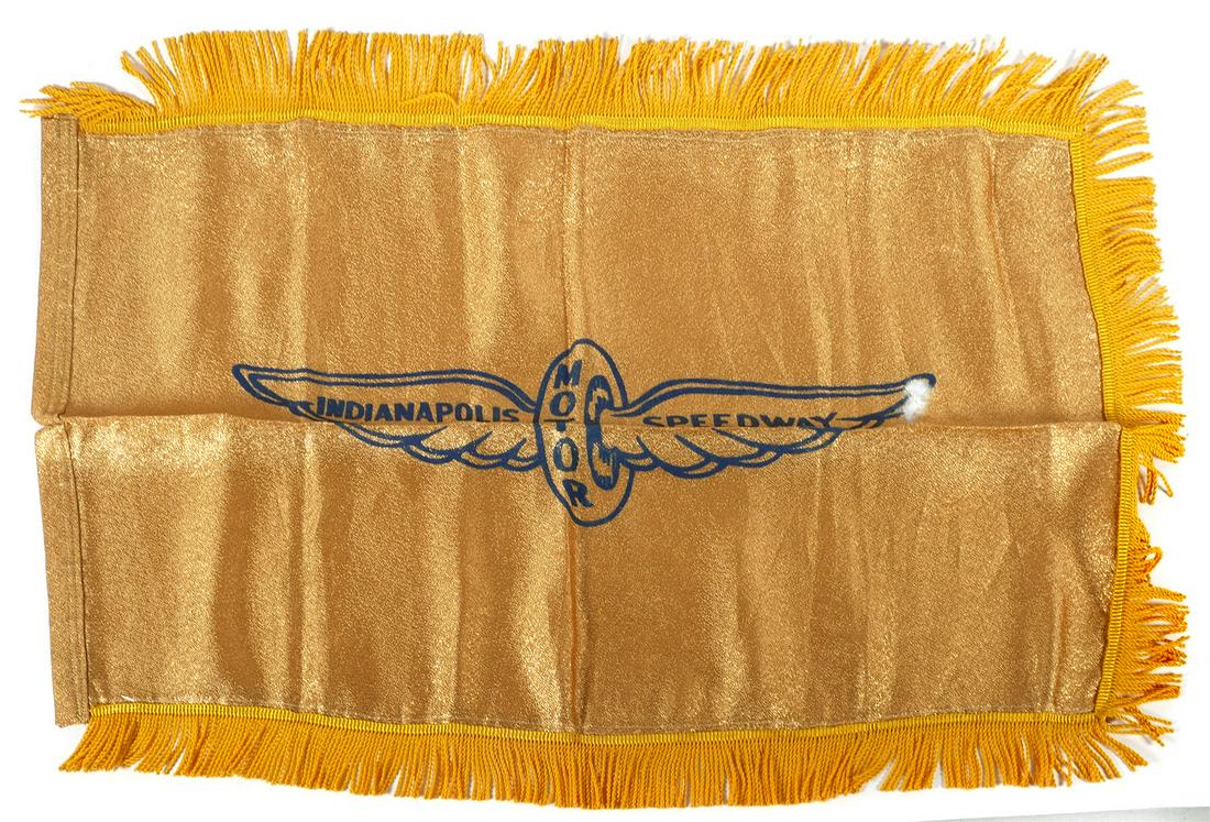 VINTAGE GOLD INDIANAPOLIS 500 RACE FLAG: Early 20th century gold lame flag with original Indianapolis Motor Speedway logo. Fold marks can be steamed out. Far right end of wing tip has hole. Measures about 21" x 32". This item can be shipped 